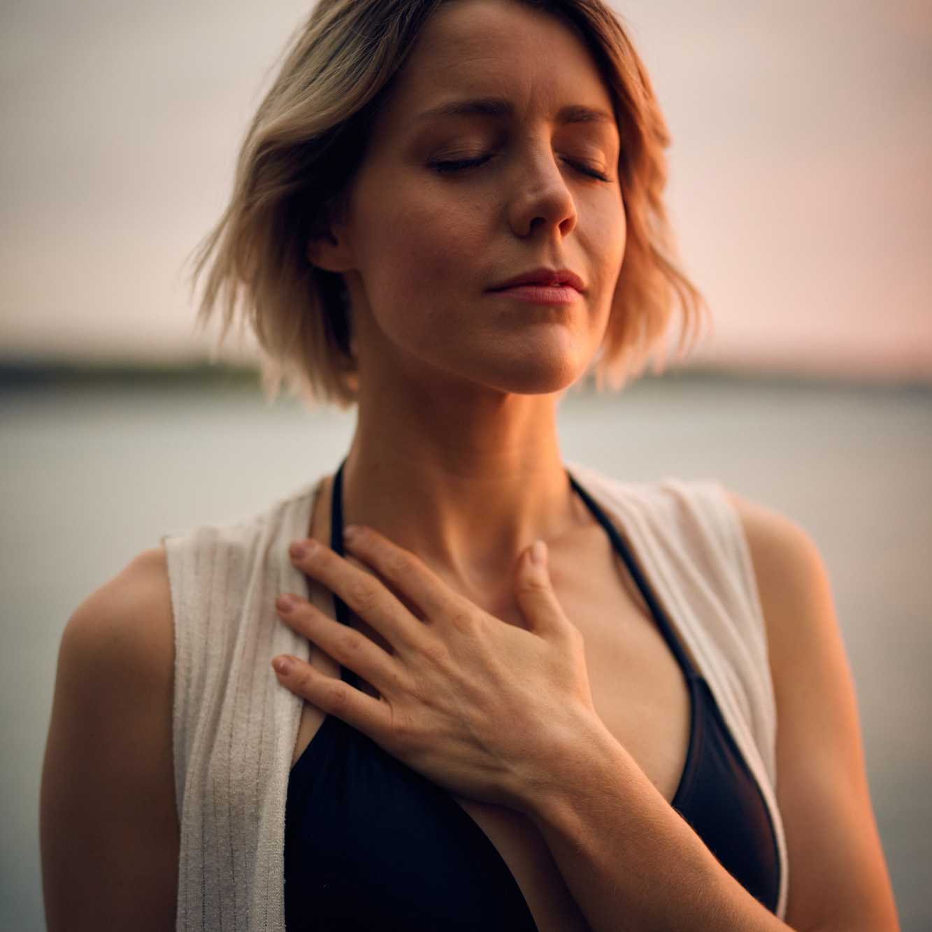 Woman with hand over heart taking a deep breath